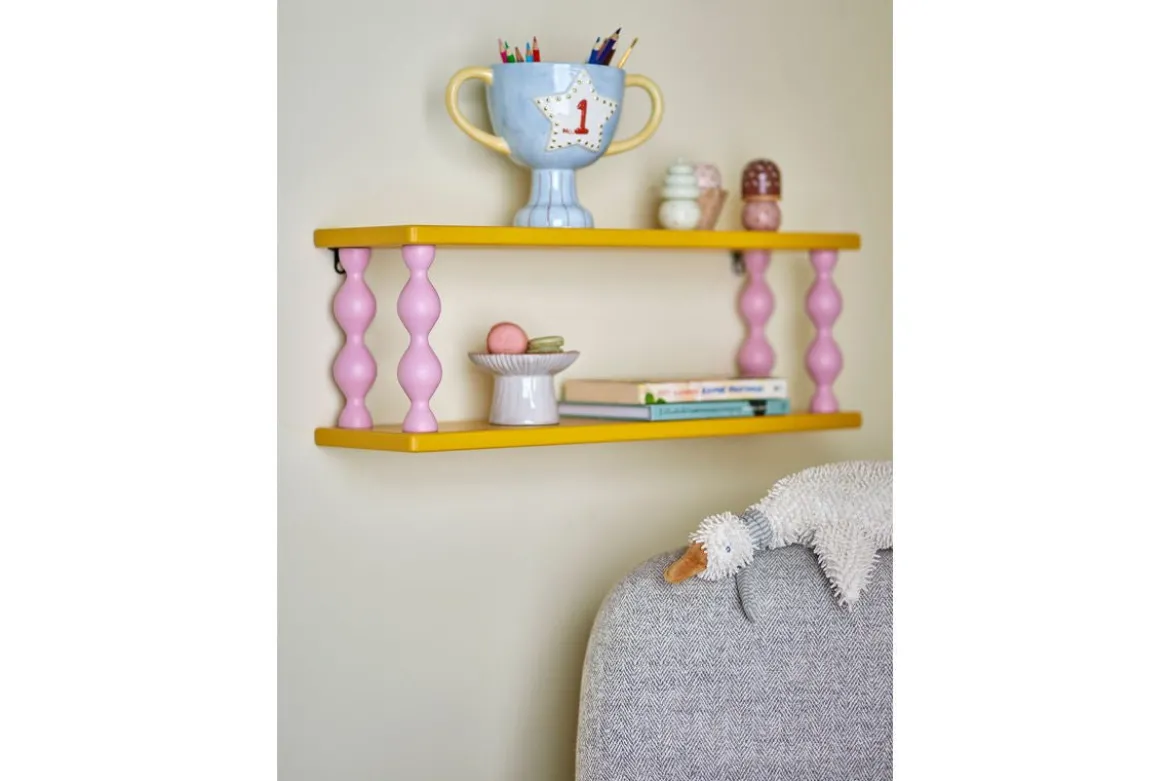 Kinderregal Lyon – Gelbes Wandregal mit rosa Beinen
