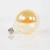 LED-Glühlampe Veya – G125-E27 im Großformat mit amberfarbenem Glas